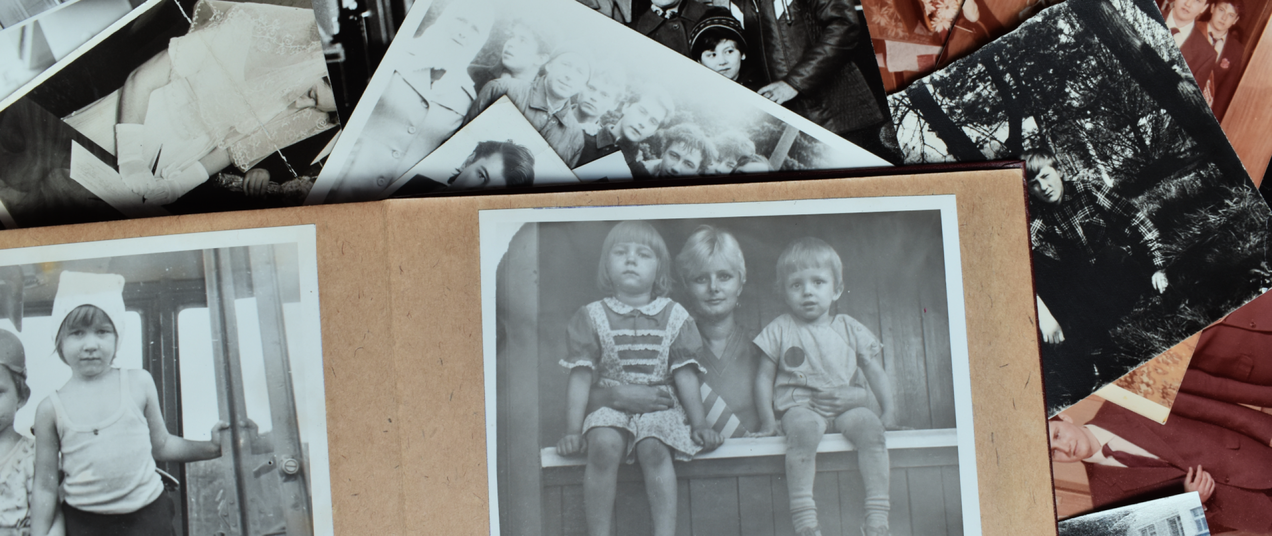 Many overlapping photographs showing family members throughtout the decades